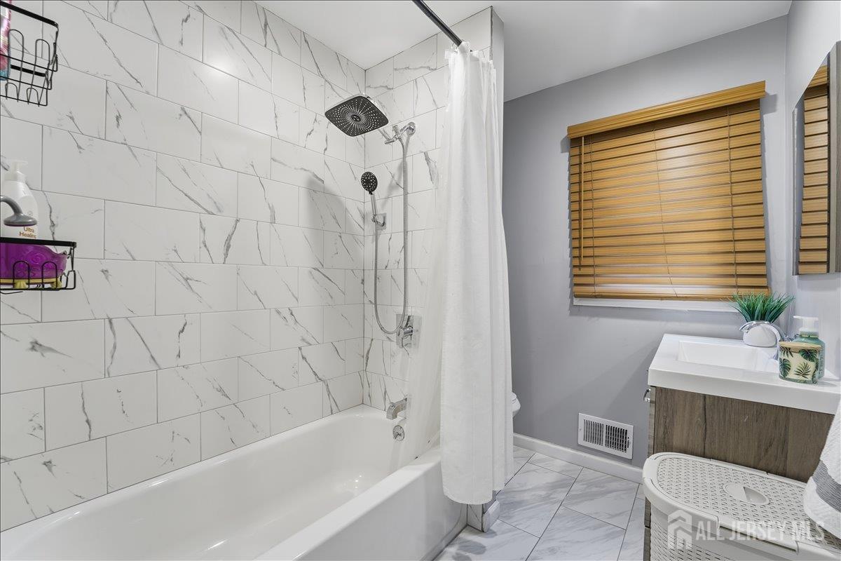 10 Maplehurst Lane Piscataway, NJ 08854 - Photo 17 of 28 a bathroom with a bathtub a window and a shower