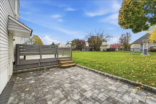 a view of a garden with a bench in the garden