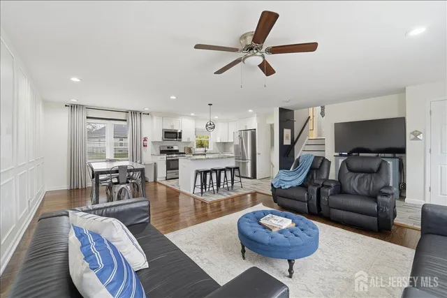 a living room with furniture and a wooden floor