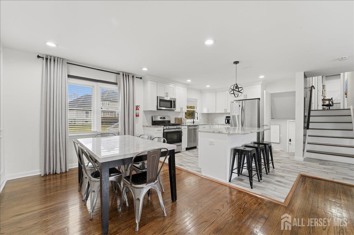 10 Maplehurst Lane Piscataway, NJ 08854 - Photo 6 of 28 a view of a dining room with furniture and wooden floor