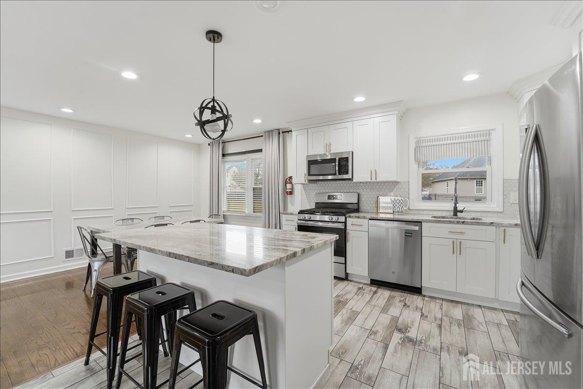 10 Maplehurst Lane Piscataway, NJ 08854 - Photo 8 of 28 a kitchen with kitchen island a sink stove and refrigerator