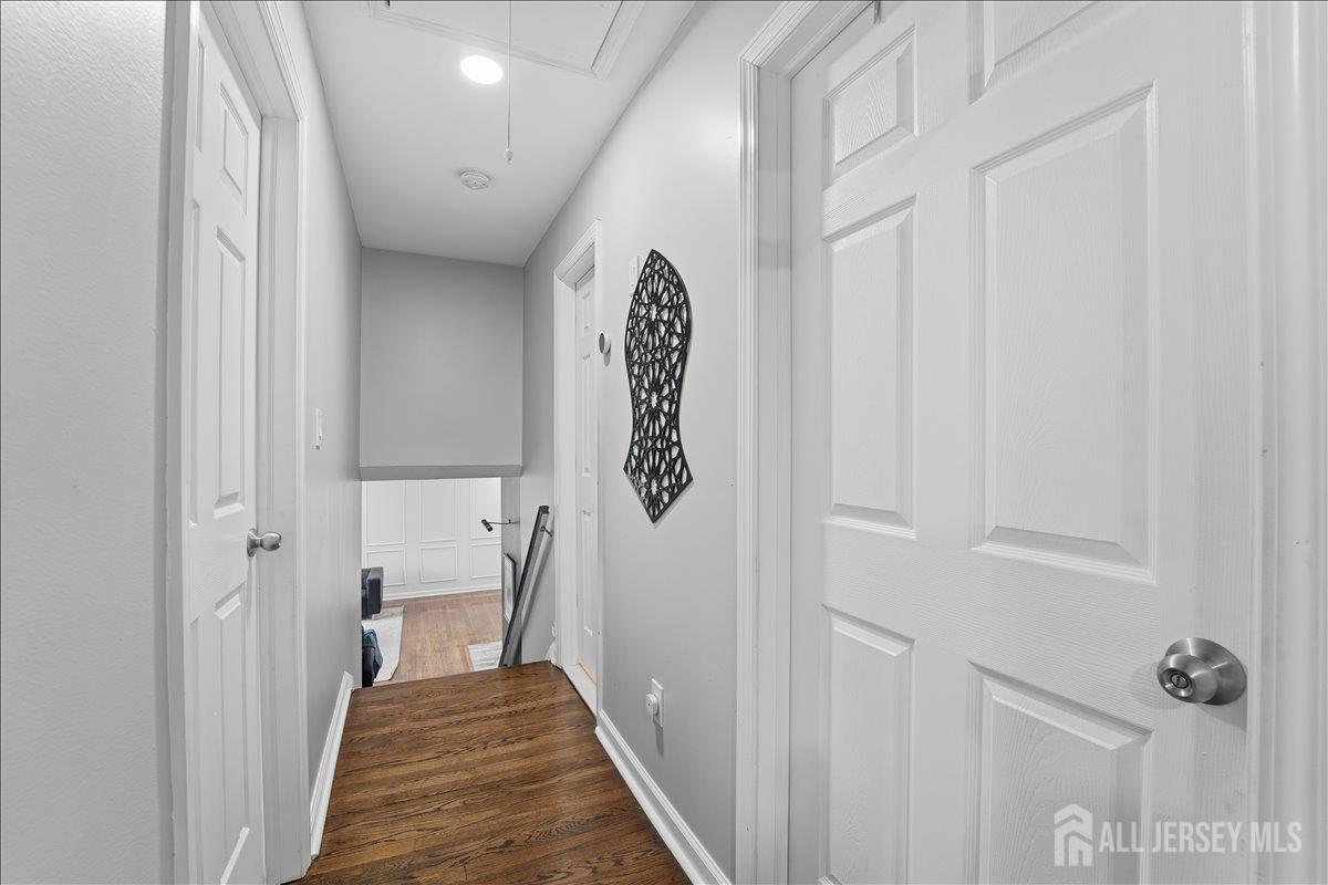 10 Maplehurst Lane Piscataway, NJ 08854 - Photo 10 of 28 a view of a hallway with wooden floor and staircase