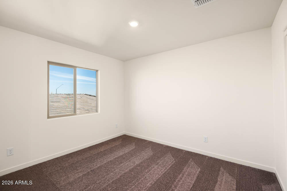 1094 Feliz Street Florence, AZ 85132 - Photo 12 of 13 an empty room with a window