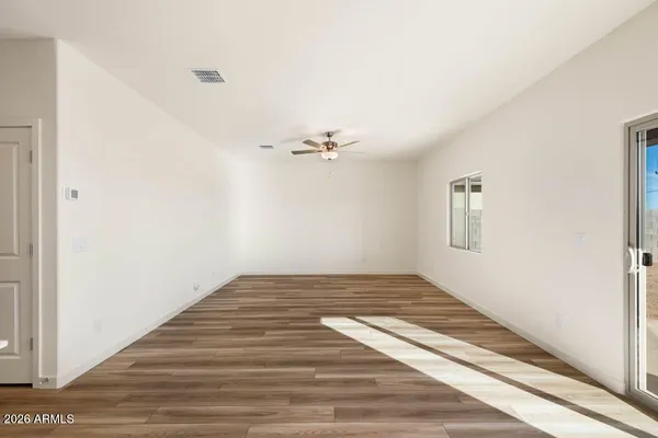 a view of a room with wooden floor and white walls