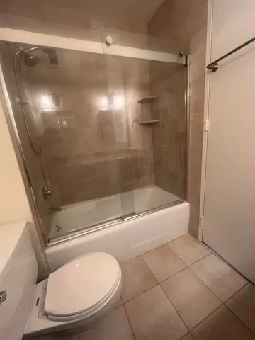 a bathroom with a shower and a toilet