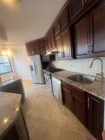 a kitchen with a sink stove and cabinets