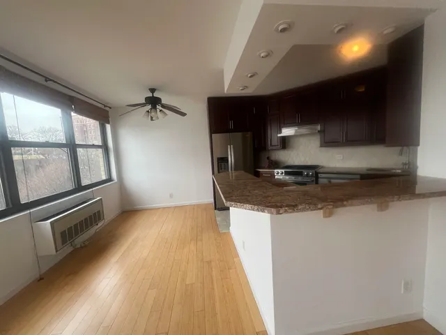a kitchen with granite countertop a sink and a stove top oven