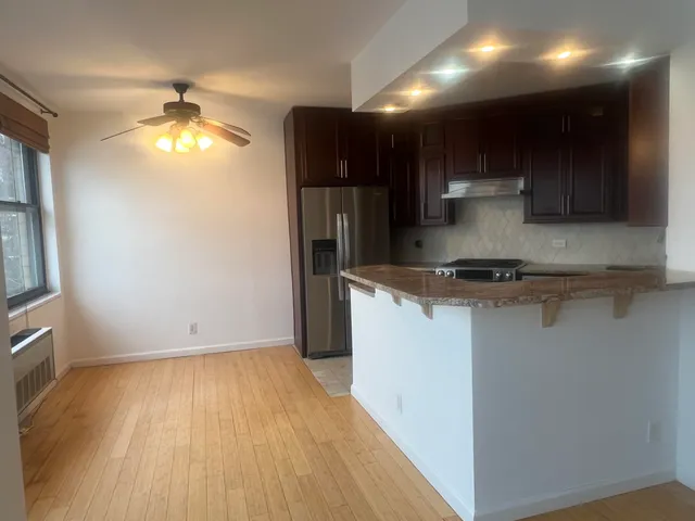 a view of kitchen with wooden floor and window