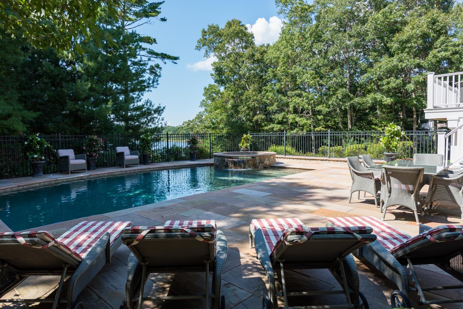 172 Bay Road Cotuit, MA 02635 - Photo 29 of 36 a view of a patio with chairs next to a lake