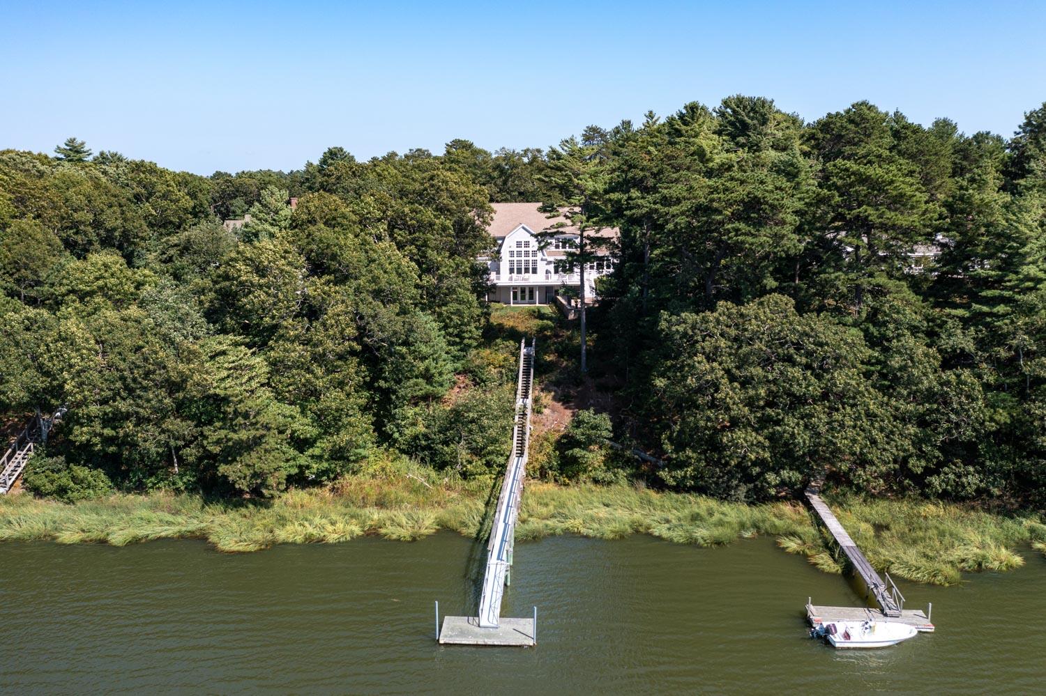 172 Bay Road Cotuit, MA 02635 - Photo 36 of 36 a house with trees in the background