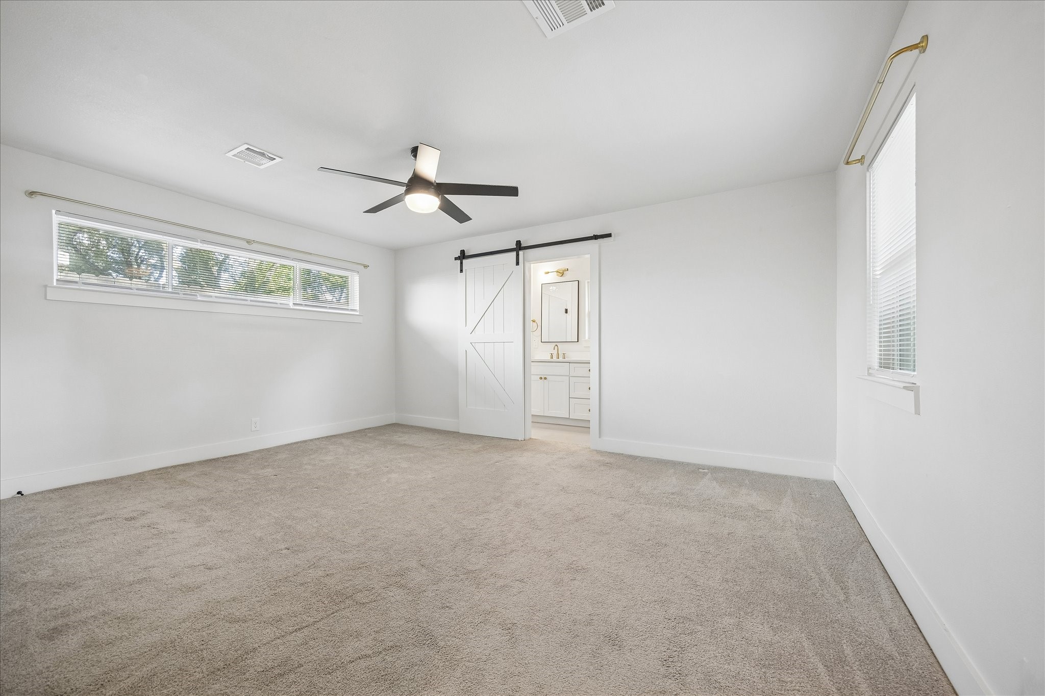 4725 Spellman Road Houston, TX 77035 - Photo 14 of 22 Another view of primary bedroom with stylish barn door leading to high-quality renovated bath.