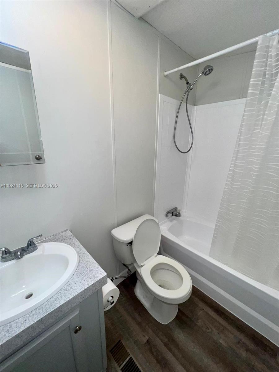 35303 Southwest 180th Avenue, Unit 399 Homestead, FL 33034 - Photo 11 of 16 a bathroom with a granite countertop sink toilet a mirror and shower