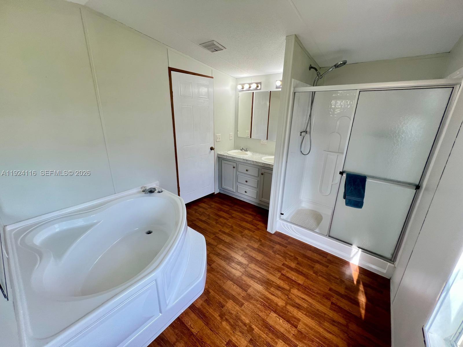 35303 Southwest 180th Avenue, Unit 399 Homestead, FL 33034 - Photo 6 of 16 a bathroom with a tub sink and shower