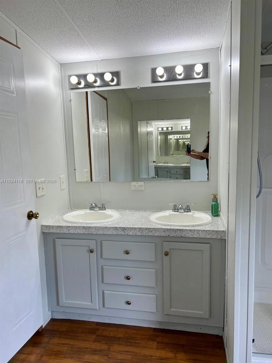 35303 Southwest 180th Avenue, Unit 399 Homestead, FL 33034 - Photo 8 of 16 a bathroom with a double vanity sink and mirror