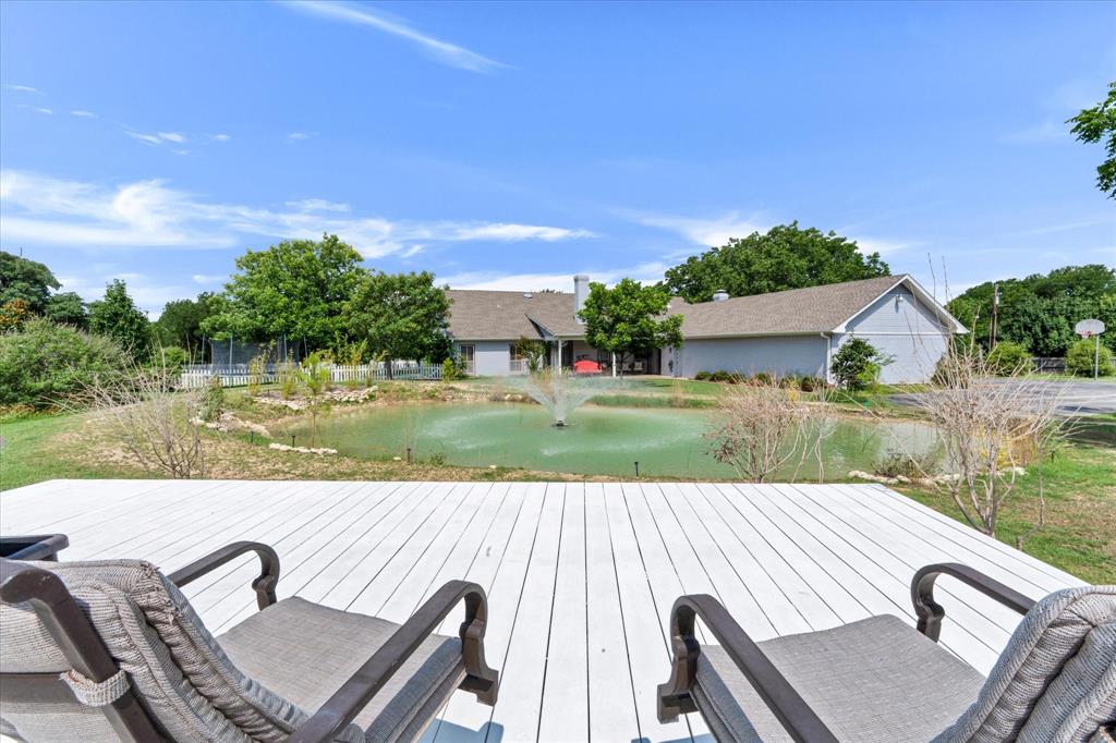2717 Clear Lake Road Weatherford, TX 76087 - Photo 27 of 40 Spacious outdoor deck overlooking a private pond with a fountain feature