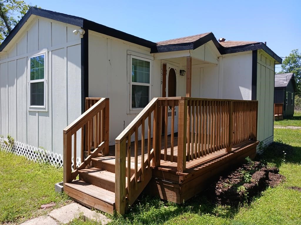 a view of a house with wooden floor roof and wooden fence