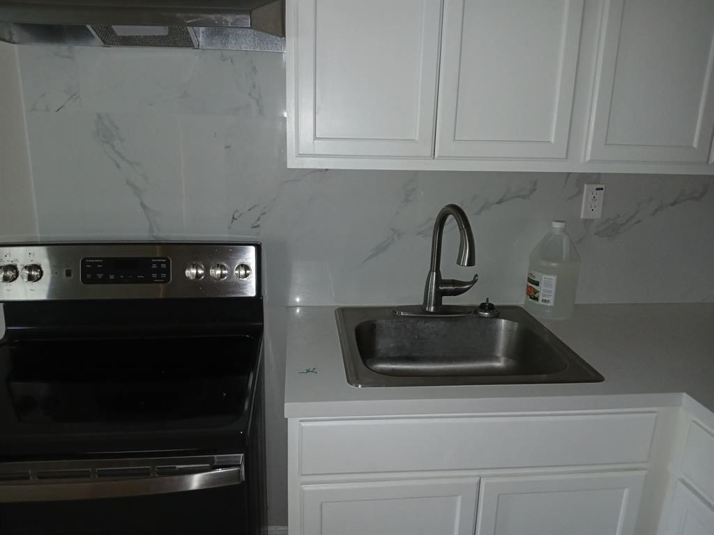 15519 Highway 6 Santa Fe, TX 77517 - Photo 11 of 14 a kitchen with a sink and cabinets