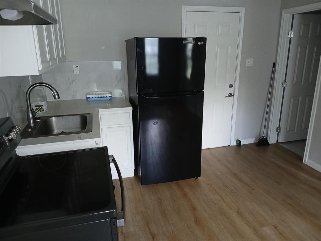 15519 Highway 6 Santa Fe, TX 77517 - Photo 12 of 14 a kitchen with a refrigerator and a stove top oven