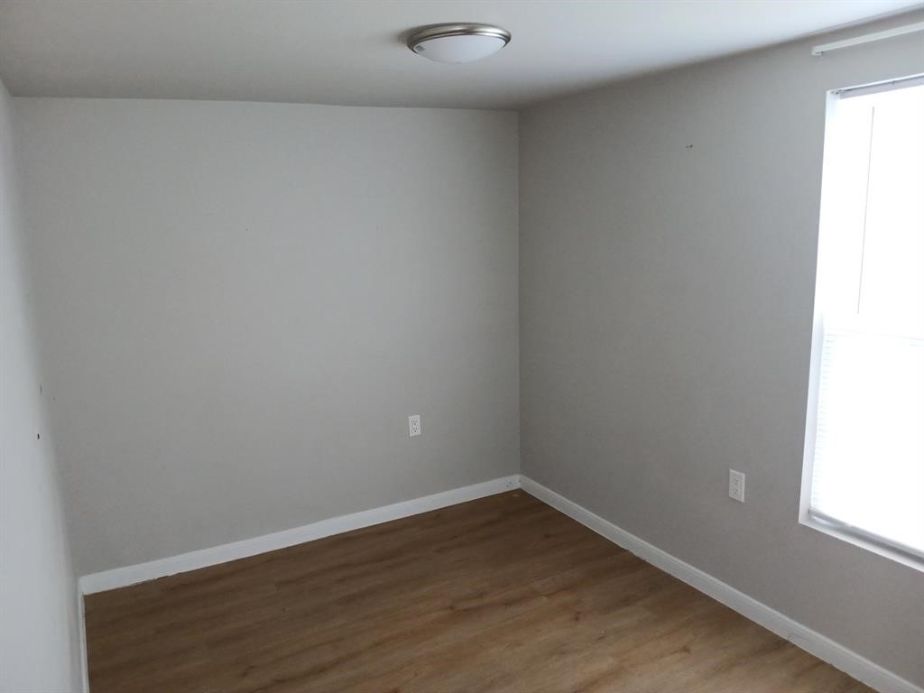 15519 Highway 6 Santa Fe, TX 77517 - Photo 7 of 14 a view of a small space with wooden floor and a window