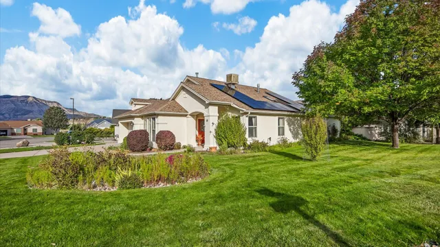 a view of a house with a big yard and a fountain