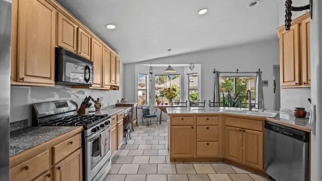 a kitchen with a sink stove and cabinets