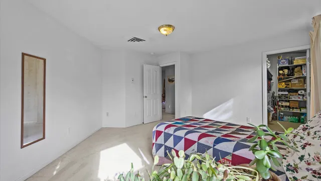 a bedroom with a bed and a book shelf
