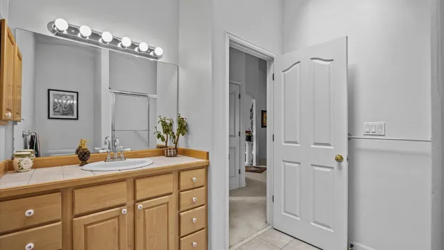 a bathroom with a sink vanity and a mirror