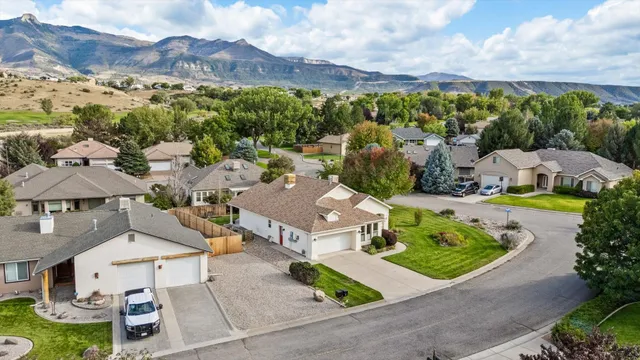 an aerial view of multiple houses with a yard