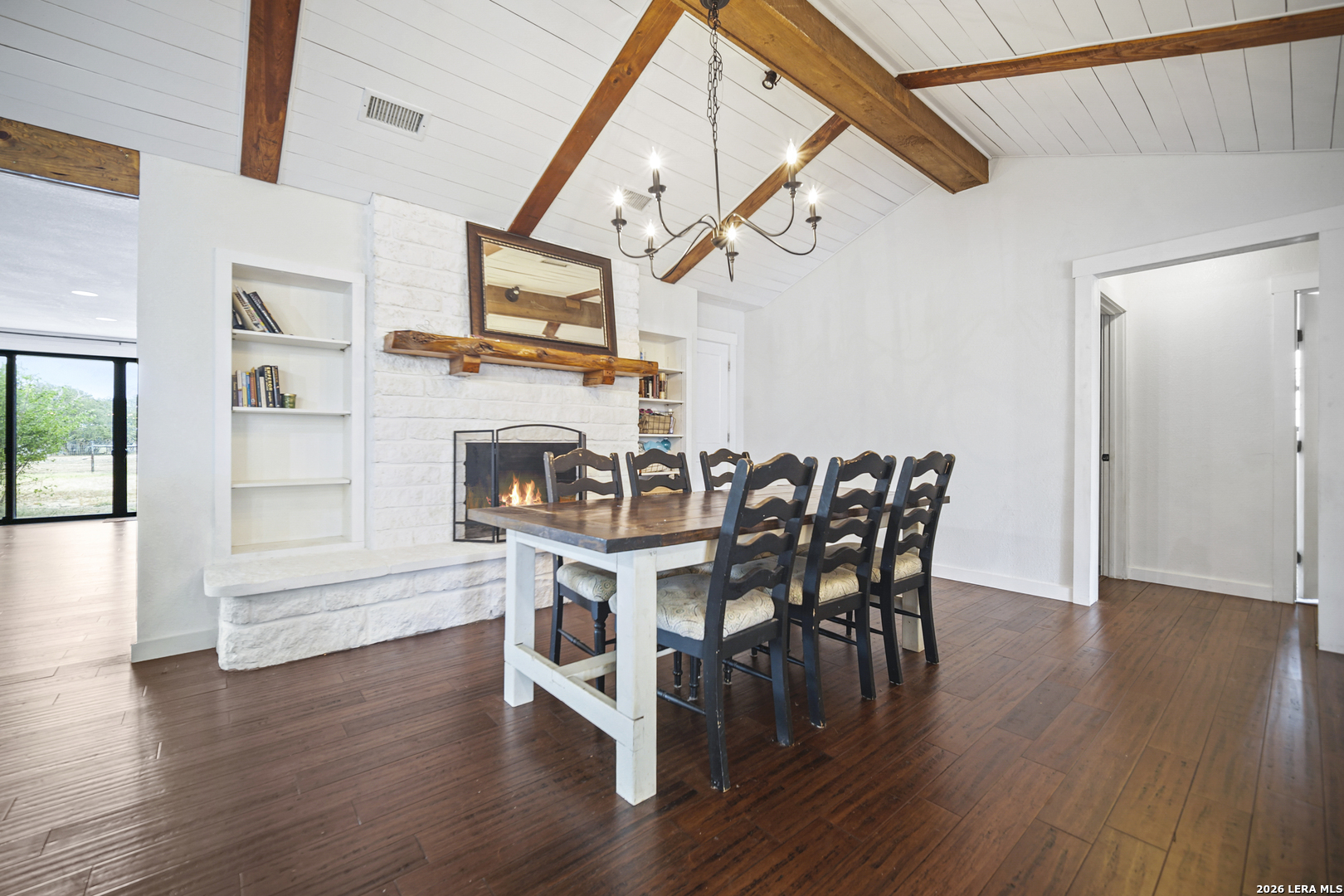 25 Poehnert Road Boerne, TX 78006 - Photo 15 of 37 a view of a dining room with furniture wooden floor and a chandelier