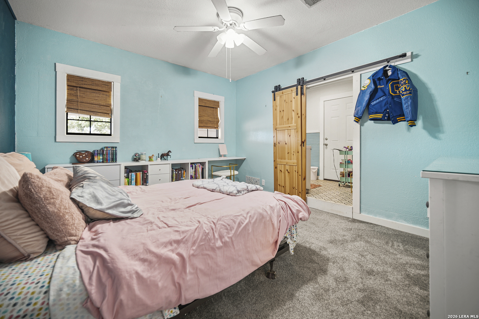 25 Poehnert Road Boerne, TX 78006 - Photo 24 of 37 a bedroom with a bed and a chandelier