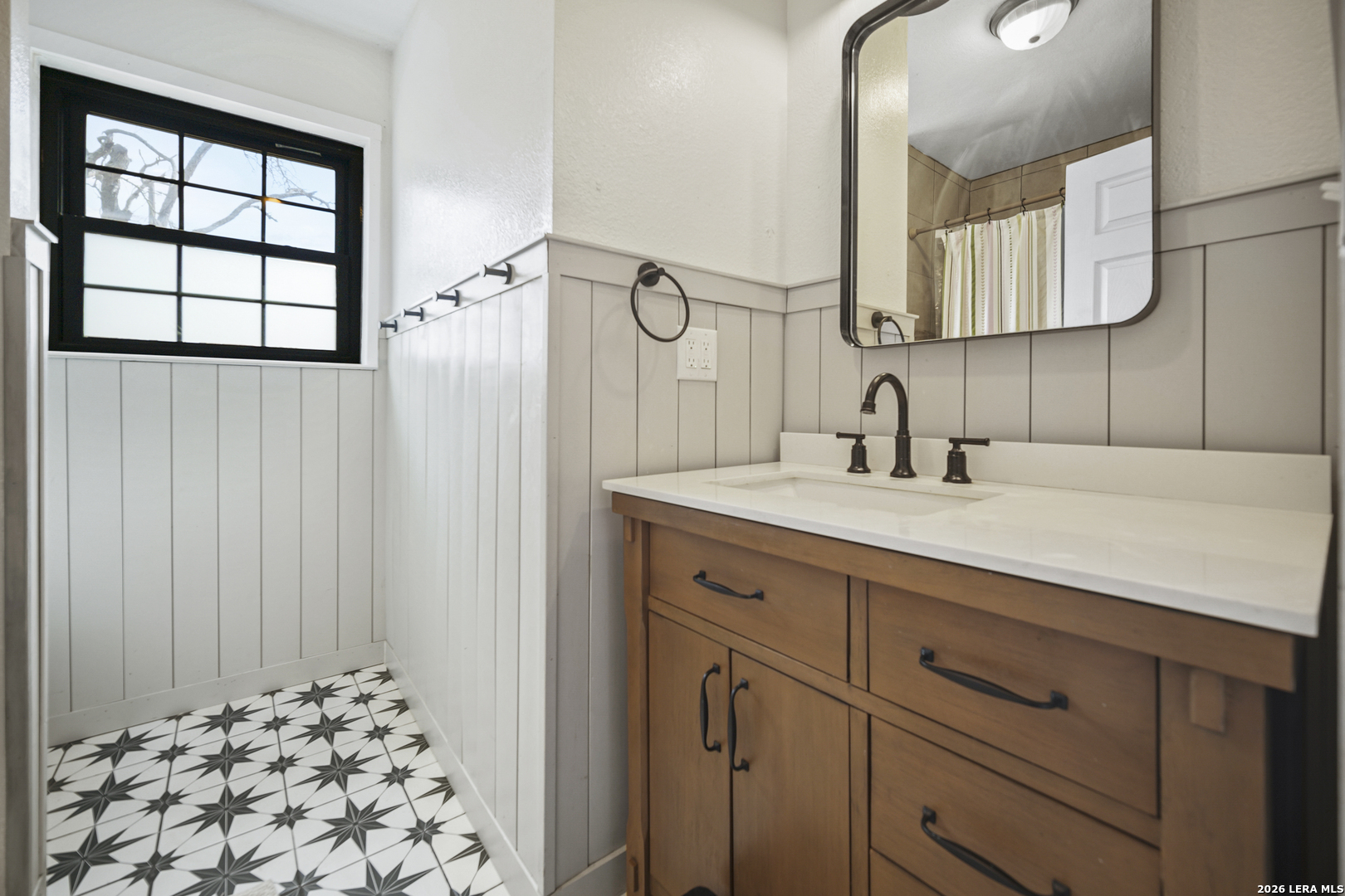 25 Poehnert Road Boerne, TX 78006 - Photo 27 of 37 a bathroom with a double vanity sink and mirror