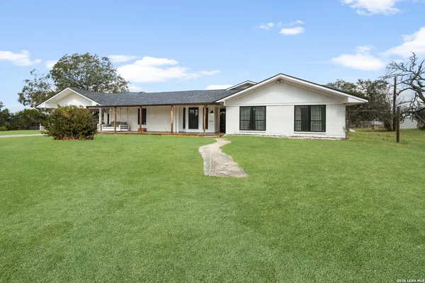 a front view of house with yard and green space