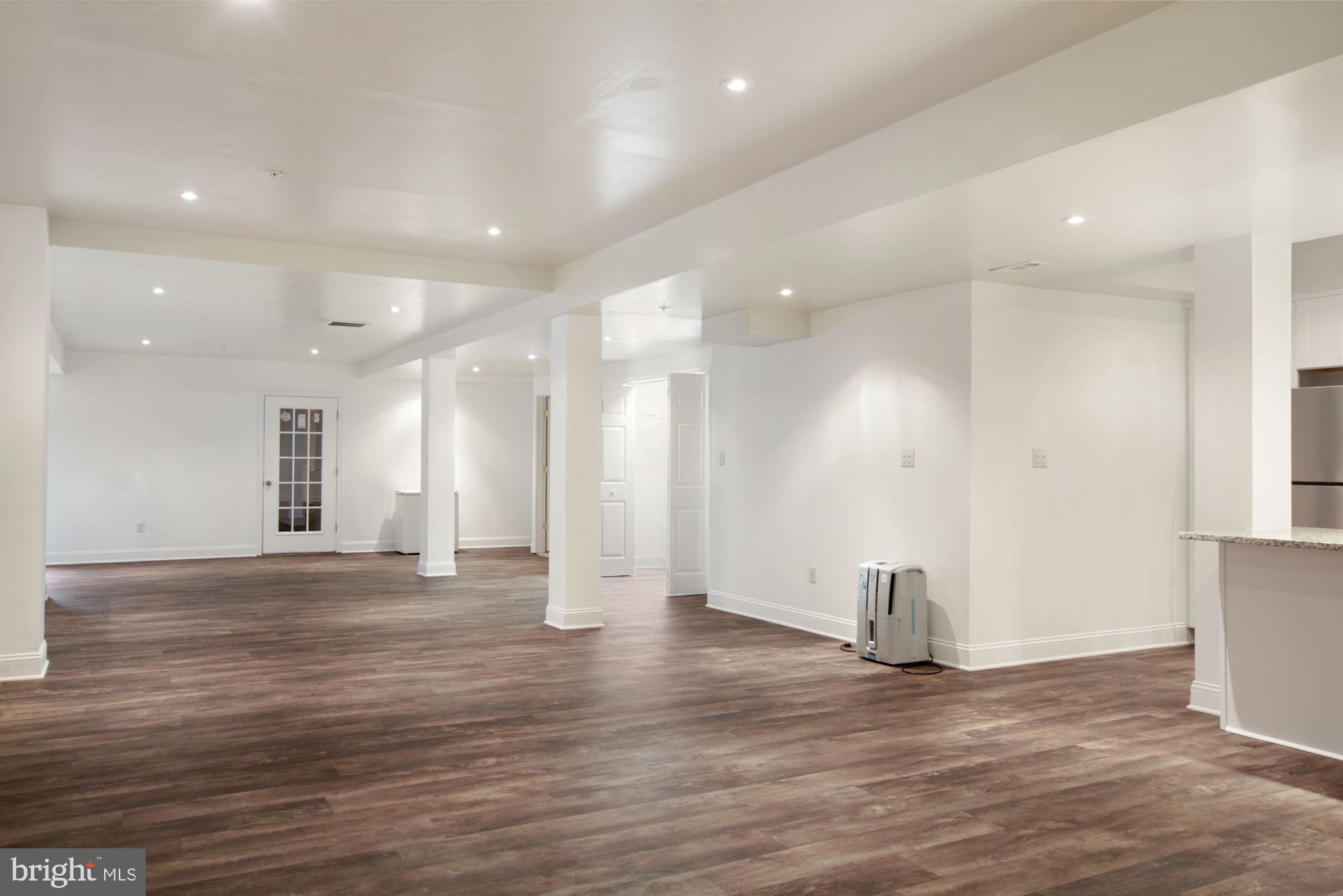 6803 Ironbridge Lane Laurel, MD 20707 - Photo 42 of 60 Large finished basement with luxury plank floors