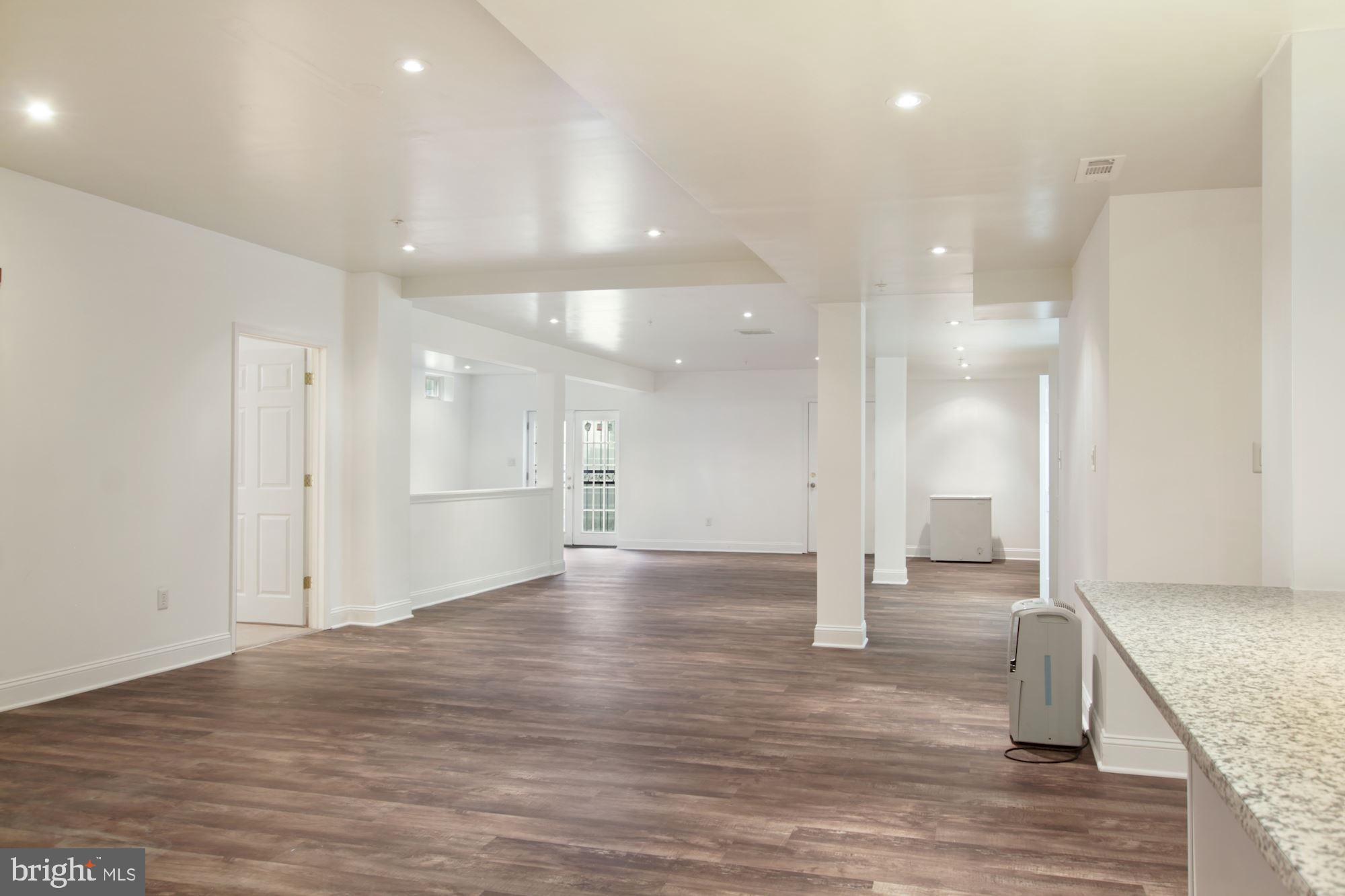 6803 Ironbridge Lane Laurel, MD 20707 - Photo 44 of 60 Large finished basement with luxury plank floors