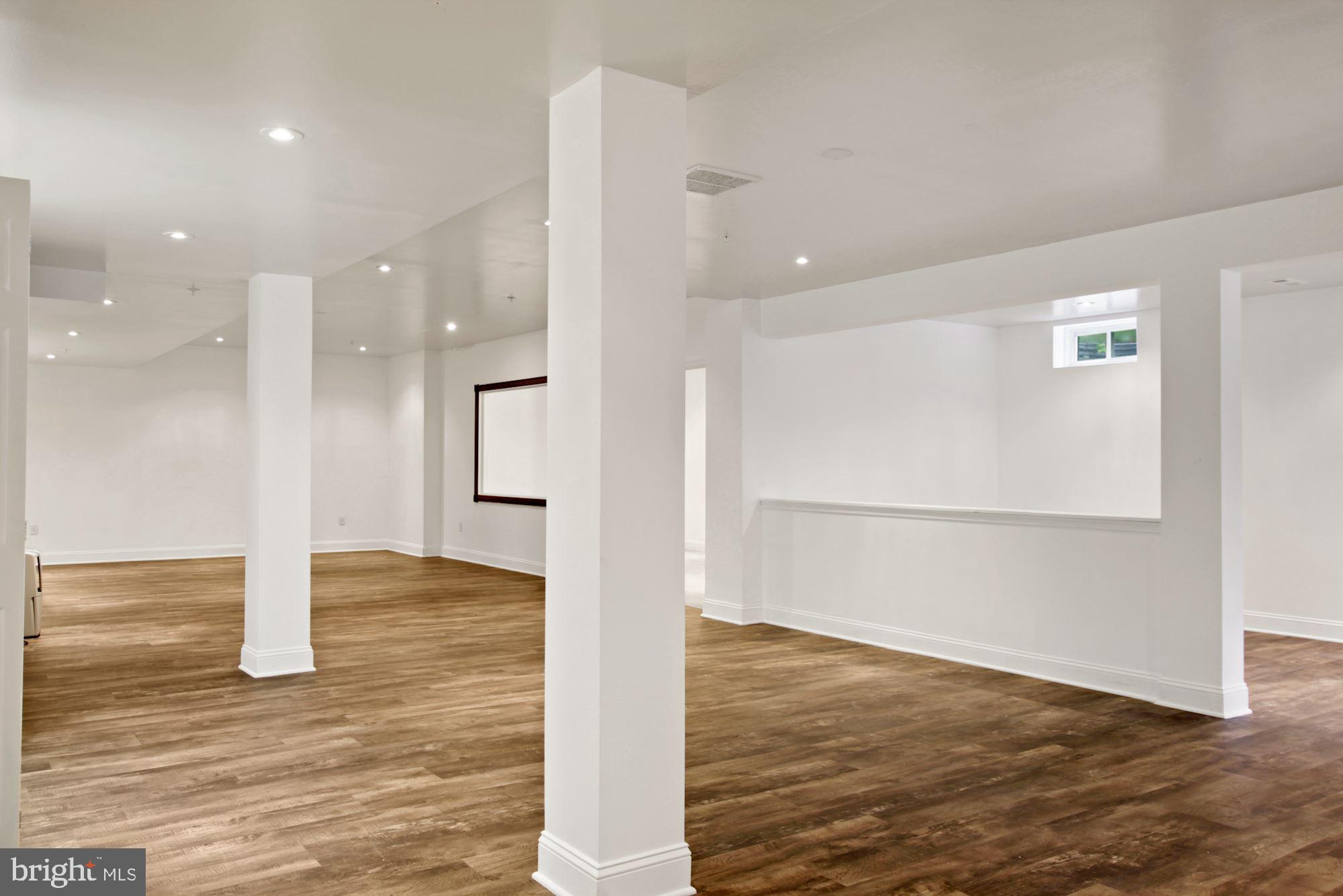 6803 Ironbridge Lane Laurel, MD 20707 - Photo 45 of 60 Large finished basement with luxury plank floors