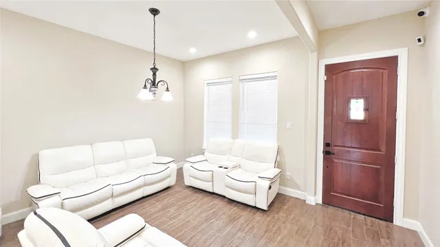 a living room with furniture and a potted plant
