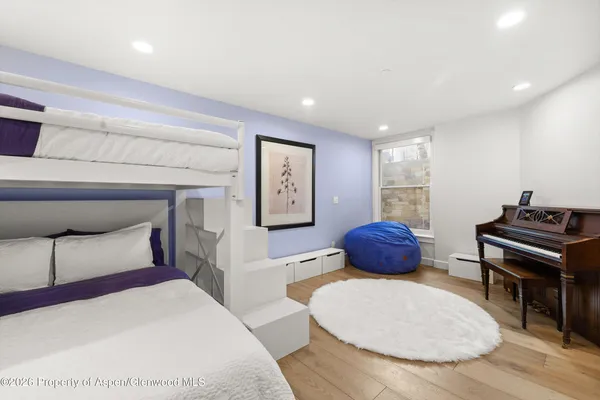 a bedroom with a bed a couch and a potted plant