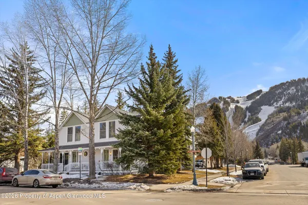 a front view of a building with trees