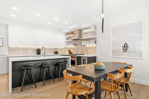 a kitchen that has a table and chairs in it