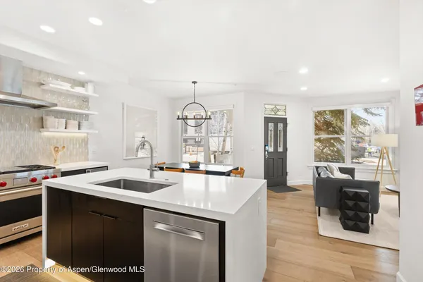 a kitchen with a sink appliances and cabinets