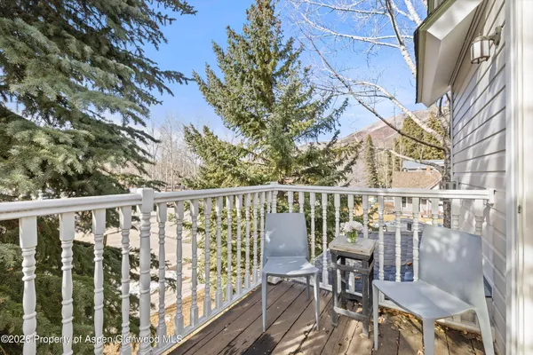 a view of balcony with furniture and wooden fence
