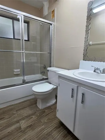 a bathroom with a toilet a sink and shower