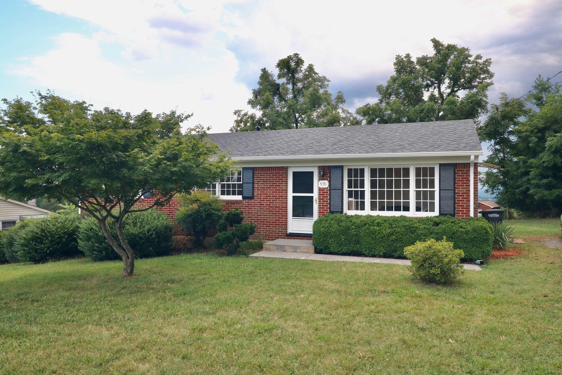 901 Olney Road Vinton, VA 24179 - Photo 1 of 42 a front view of a house with a yard and garage