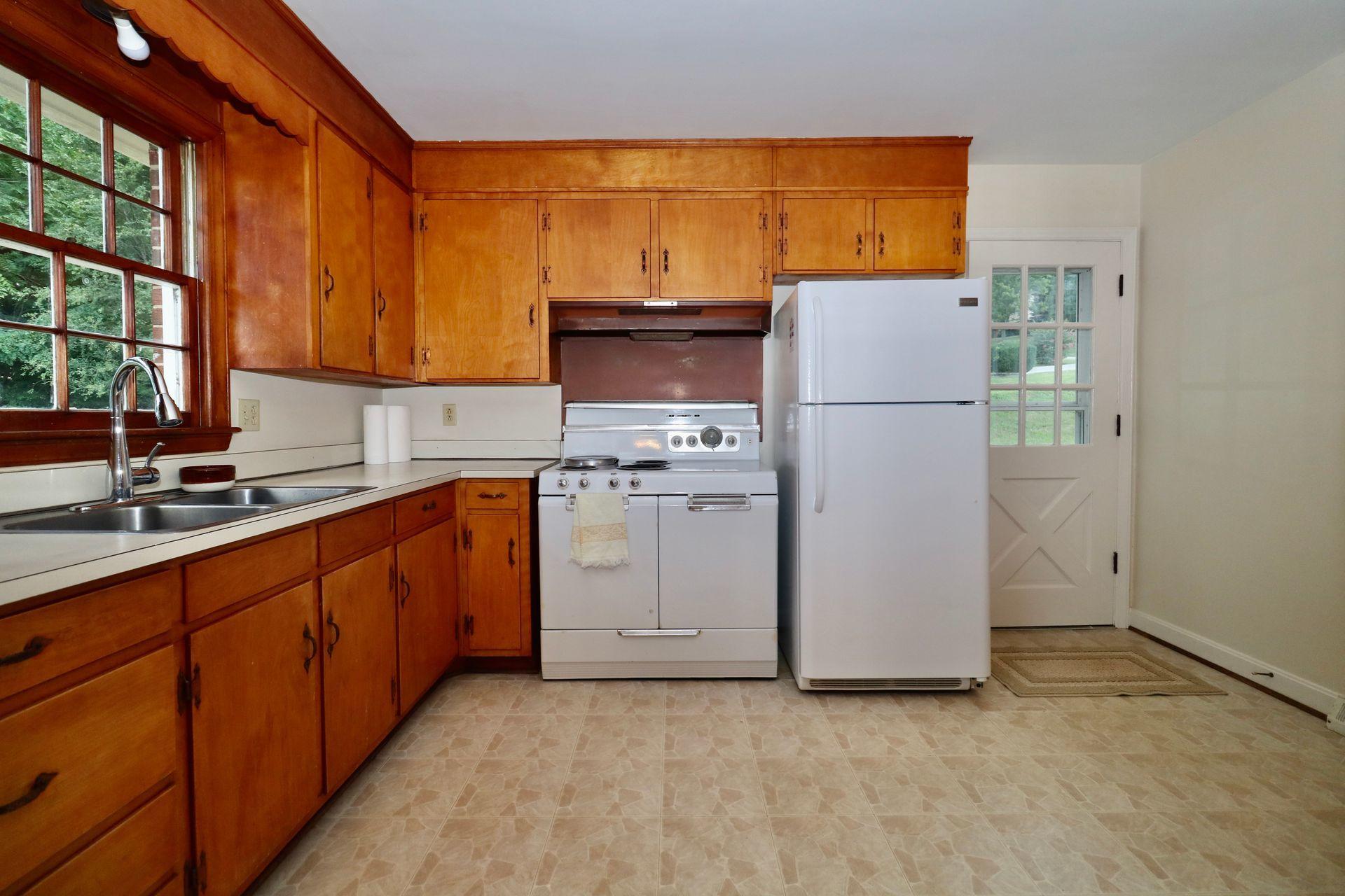 901 Olney Road Vinton, VA 24179 - Photo 19 of 42 a kitchen with stainless steel appliances a refrigerator sink and cabinets