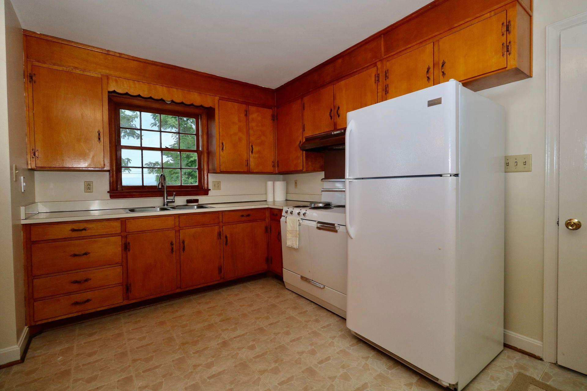901 Olney Road Vinton, VA 24179 - Photo 20 of 42 a kitchen with sink a refrigerator and window
