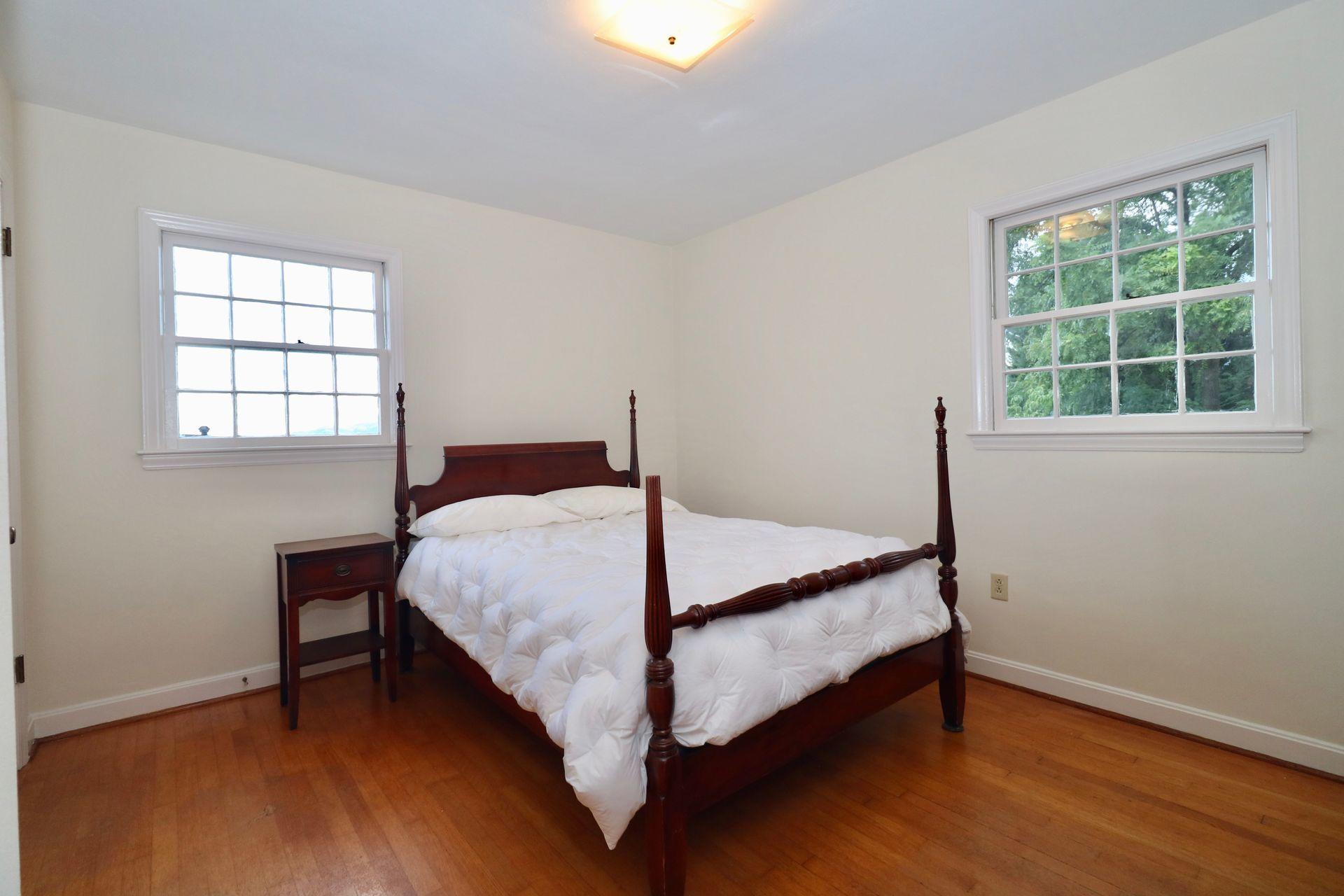 901 Olney Road Vinton, VA 24179 - Photo 22 of 42 a bed sitting in a bedroom next to a window