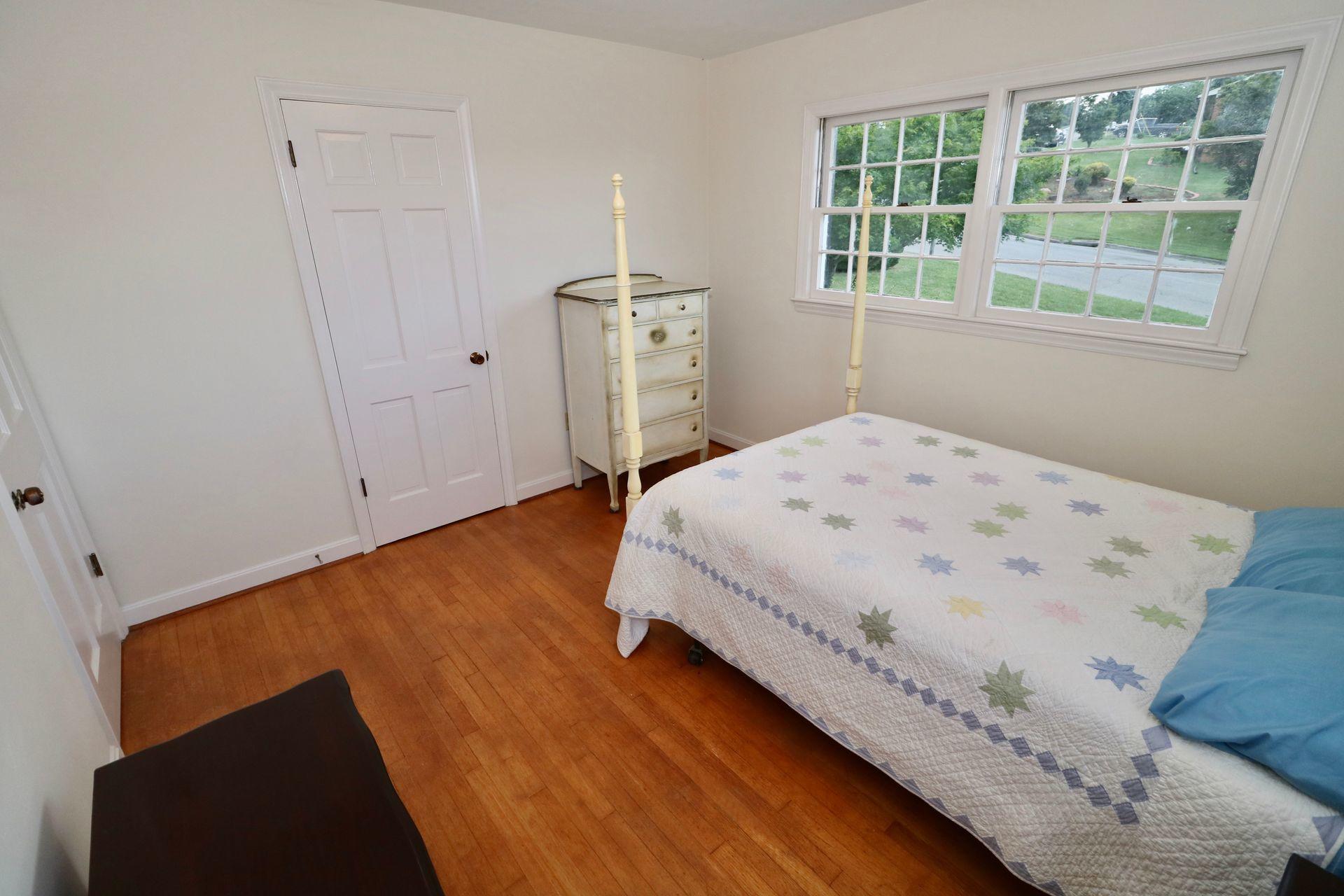 901 Olney Road Vinton, VA 24179 - Photo 27 of 42 a bedroom with a bed and wooden floor