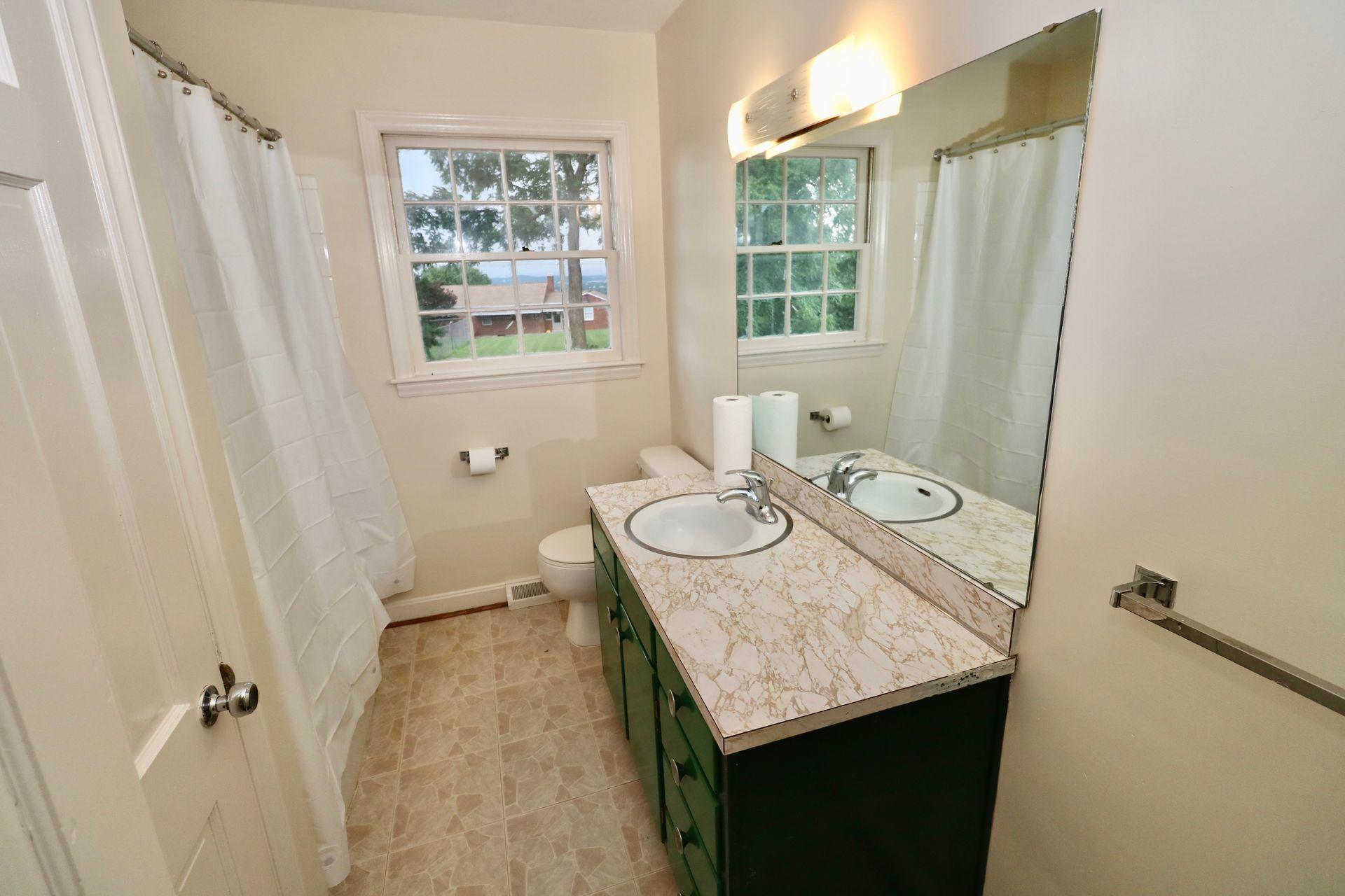 901 Olney Road Vinton, VA 24179 - Photo 28 of 42 a bathroom with a granite countertop sink and a mirror