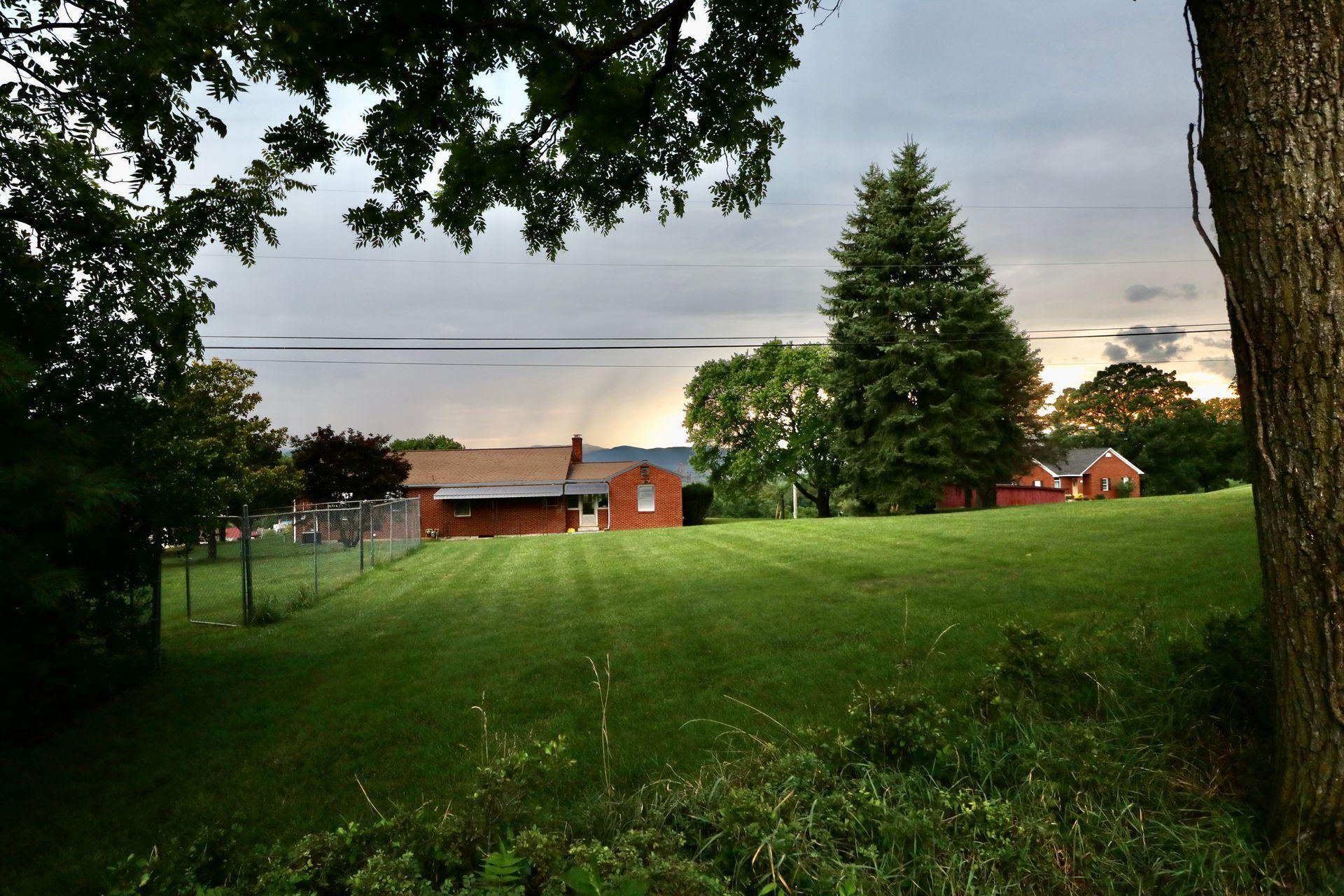 901 Olney Road Vinton, VA 24179 - Photo 40 of 42 a backyard of a house with lots of green space and lake view