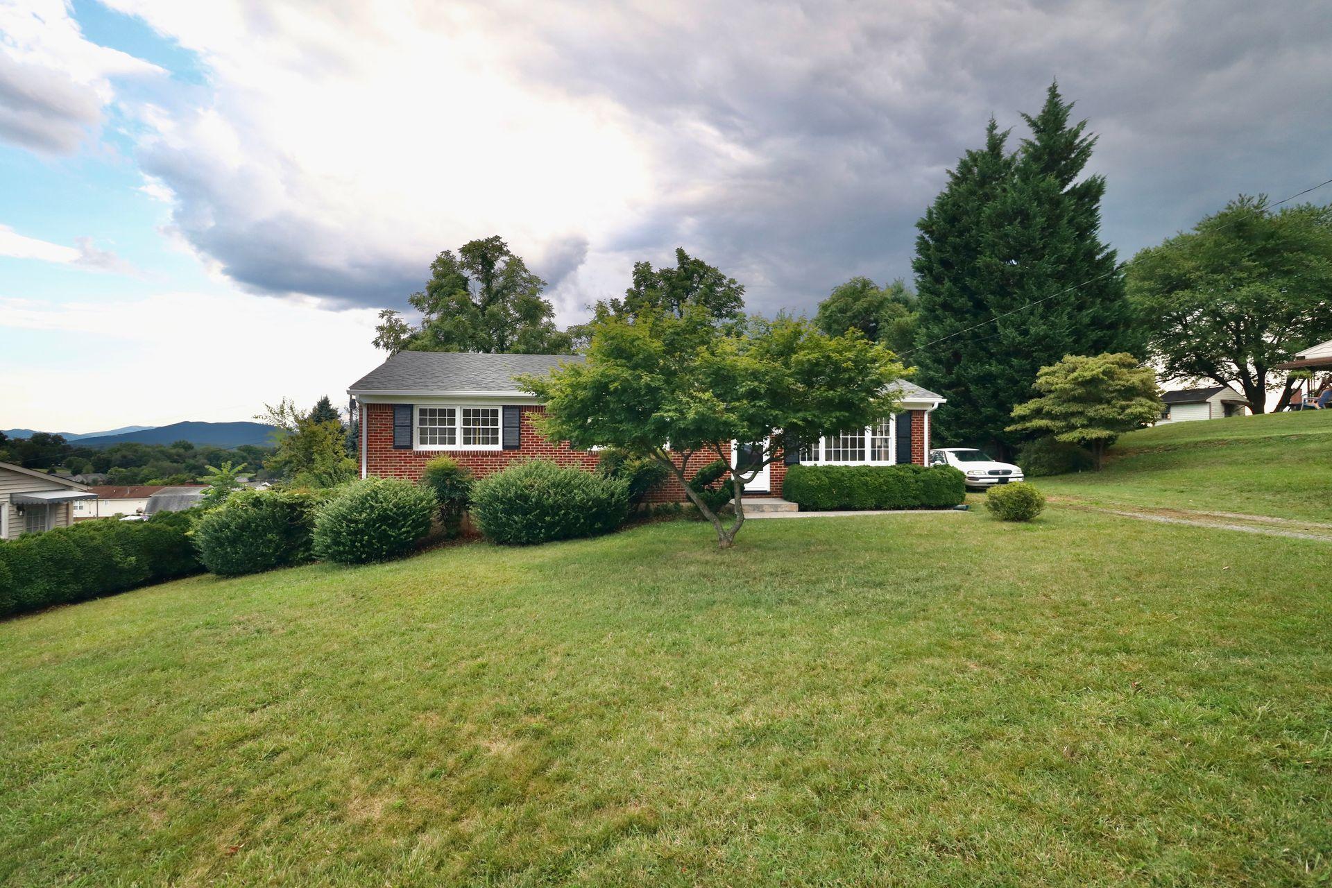 901 Olney Road Vinton, VA 24179 - Photo 6 of 42 a front view of a house with a yard